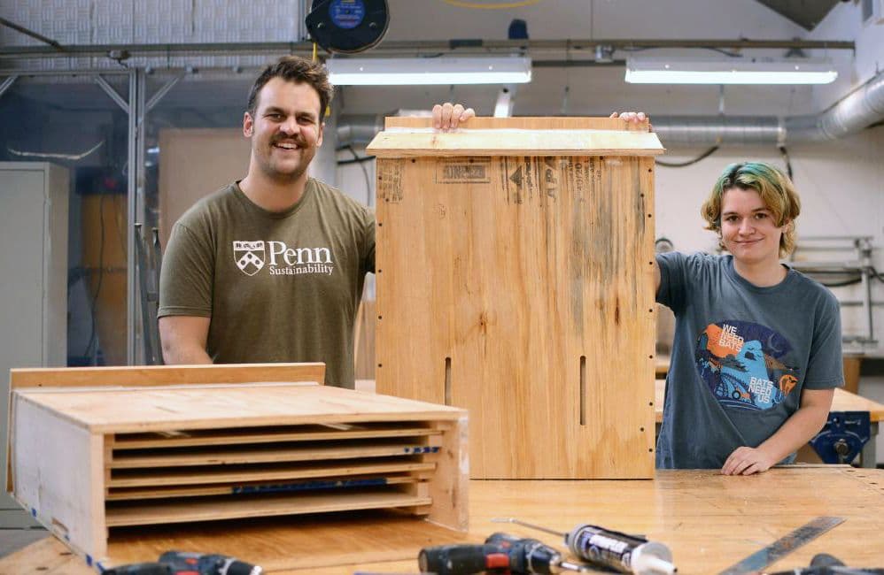 Daniel Flinchbaugh (left), Penn Facilities and Real Estate Services assistant landscape planner  and Nick Tanner(right), Penn undergraduate, with a nearly finished bat box in the Weitzman School of Design Fabrication Lab (image courtesy of John Donges/University of Pennsylvania School of Veterinary Medicine)